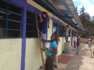 Diamante and classmate, Lianne, aren't afraid to get dirty working on the new school.